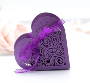 Close-up of heart-shaped hollow gift box in purple with laser-cut vine patterns