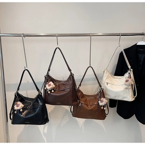 Row of four vintage-style large capacity tote bags in black, brown, caramel and white leather