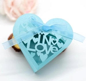 Detail of sky blue heart-shaped gift box with LOVE hollow pattern and blue ribbon bow