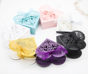 Detail of heart-shaped laser-cut gift boxes with elegant floral patterns and ribbon bows