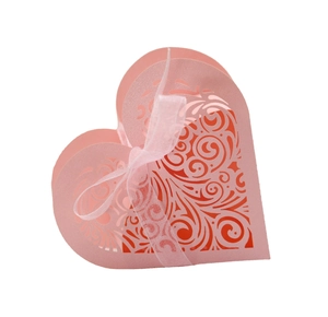 Pink heart-shaped laser-cut gift box with floral patterns and white ribbon bow