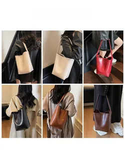 Model wearing a large capacity bucket bag in multiple colors to show styling options