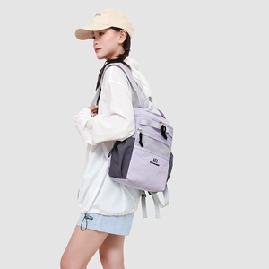 Lavender and grey waterproof nylon backpack showing size and scale on a female model