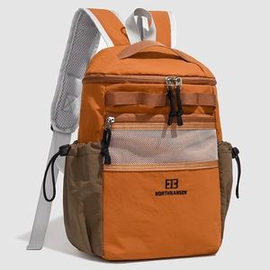 Detail of orange and brown outdoor backpack featuring mesh shoulder straps and zip pocket