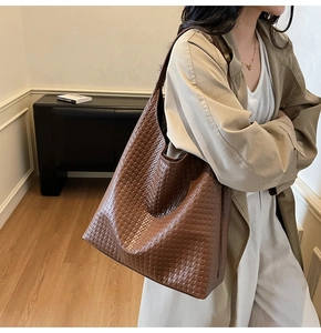 Detail of woven leather pattern and large capacity on dark brown tote shoulder bag
