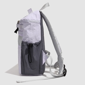 Detail view of water-resistant nylon backpack with side drawstring and mesh pockets