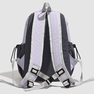 Detail view of padded shoulder straps and adjustable chest buckle on the backpack