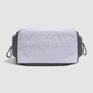 Detail of the water-resistant wrinkled nylon fabric and stitching on the purple backpack