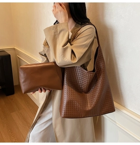 Detail of woven texture tote bag with matching leather pouch in retro dark brown style