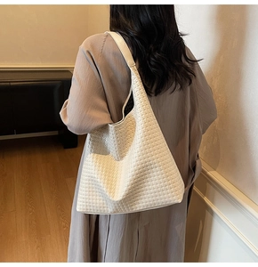 Detailed close-up of a white woven texture hobo bag showing large capacity and soft PU material