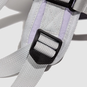 Detailed shot of reinforced shoulder strap stitching and adjustable buckle on travel backpack