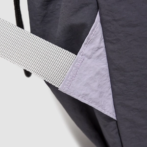 Detailed close-up of heavy-duty nylon fabric stitching and reinforced purple triangle joint