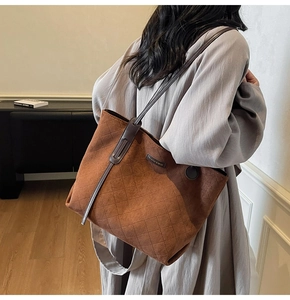 Brown suede tote bag with diamond quilting and fashion logo detail on shoulder strap