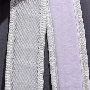 Detail of breathable honeycomb mesh shoulder straps and lilac fabric with reinforced edges