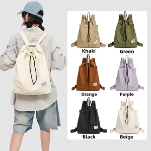 Detail view of colorful nylon drawstring backpacks in various colors with logo patch