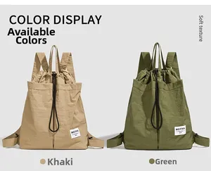 Detail view showing khaki and green drawstring backpacks in water-resistant nylon fabric