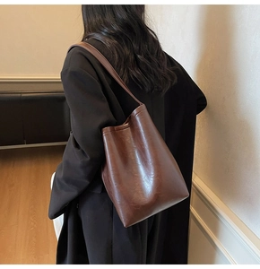 Detail showing the large capacity and draping effect of the brown vintage tote bag
