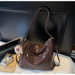 Deep brown large capacity faux leather tote bag featuring a cute lion plush pendant