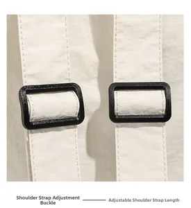 Detail of adjustable shoulder strap buckle on a cream white sports backpack