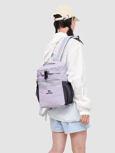 Lavender and black waterproof nylon backpack for commuting and school shown on a model
