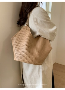 Close-up of beige woven bucket bag showing intricate cross-knit texture and retro style