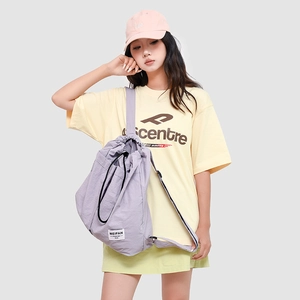 Detail of lavender nylon backpack featuring the Meifan brand label and drawstring closure