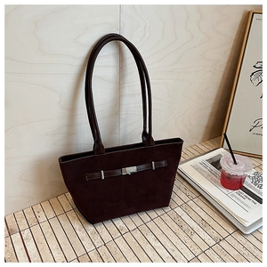 Detail of dark brown faux suede tote bag with leather strap and silver buckle detail