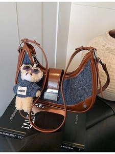 Denim half-moon crossbody bag with quilted patterns and a cute plush bear charm