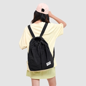Close-up of black drawstring backpack with MEIFAN BAG woven label for sports or commute