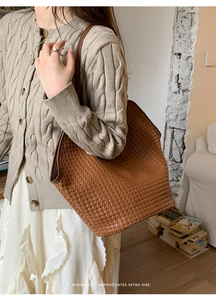Minimalist brown woven leather tote bag with retro vibe styled in cozy room setting