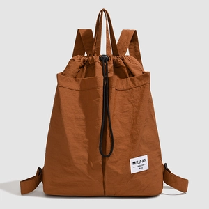 Detailed texture of brown nylon drawstring backpack with Meifan fashion brand tag