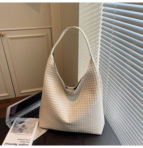 Detail of white woven PU leather tote bag with a soft texture for daily commuting