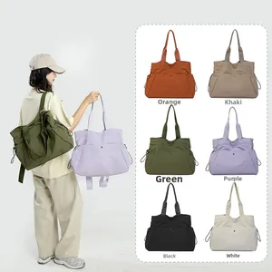 Detail view of water-resistant nylon tote bag in six colors with multi-pocket design