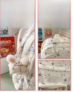 Detailed view of cream canvas backpack with star prints and plush star charm accessory
