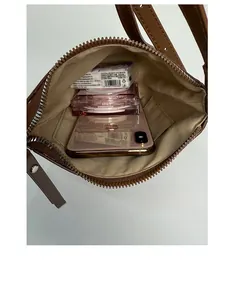 Top view of spacious interior of brown leather bucket bag showing compartments and lining