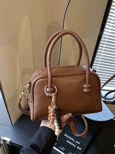 Brown vintage leather-textured bowling handbag with decorative beads and crossbody strap