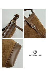 Detail view of brown matte bucket bag showing silver zipper and adjustable strap buckle