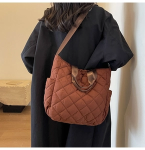 Detailed back view of a brown quilted tote bag showing wide straps and large capacity