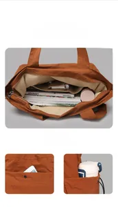 Detailed interior compartments and pockets of large caramel orange commuter tote bag