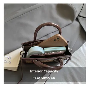 Detail view of leopard print handbag showing interior capacity for phone and cosmetics