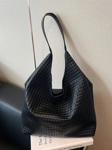 Minimalist black woven faux leather tote bag in a spacious hobo design for women