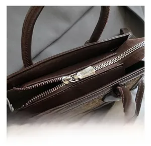 Close-up of high-quality silver metal zipper and leopard print texture on small handbag