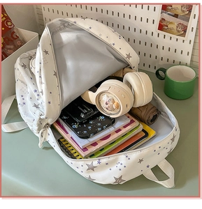 Spacious interior of white star-patterned backpack with laptop and daily essentials