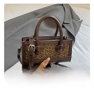 Brown leather leopard print mini handbag with silver buckles and adjustable strap