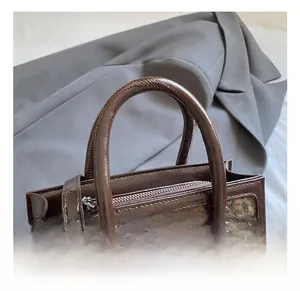 Macro view of leopard print texture and silver zipper detail on vintage shoulder bag