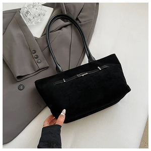 Detailed view of black matte suede tote bag with metallic buckle and slim strap decoration