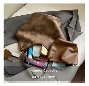 Macro detail of brown vintage tote bag capacity showing tablet, phone, and cosmetics