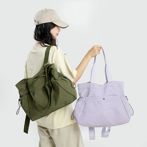 Detailed view of dark green and lilac waterproof nylon backpacks for women