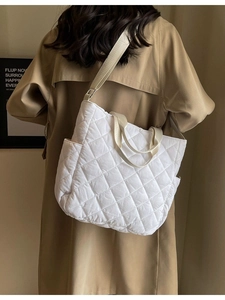 White quilted tote bag with adjustable shoulder strap and large capacity for daily use