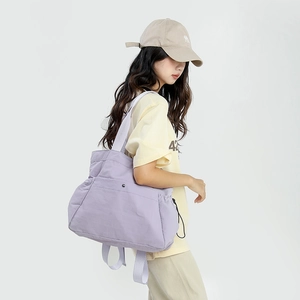 Detail view of light purple large tote bag featuring side pockets and drawstring details